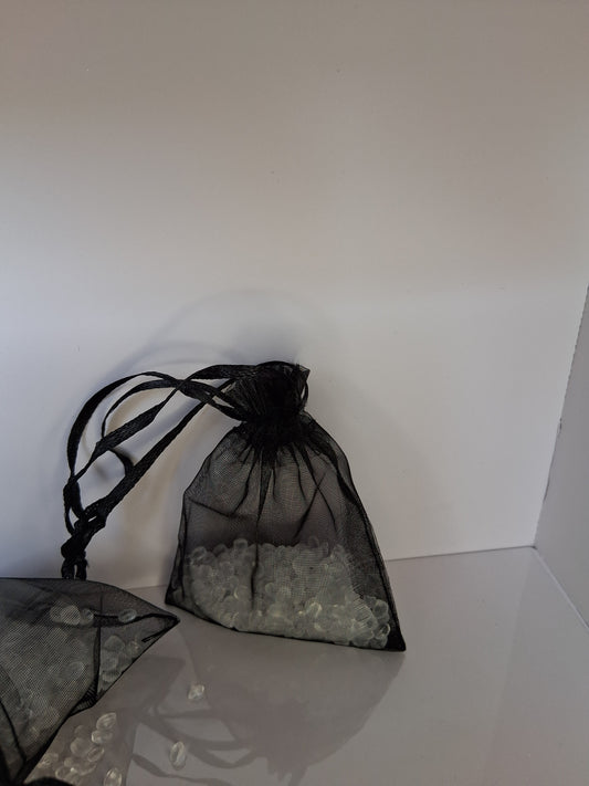 Black drawstring bag with clear scented aroma beads on a white background