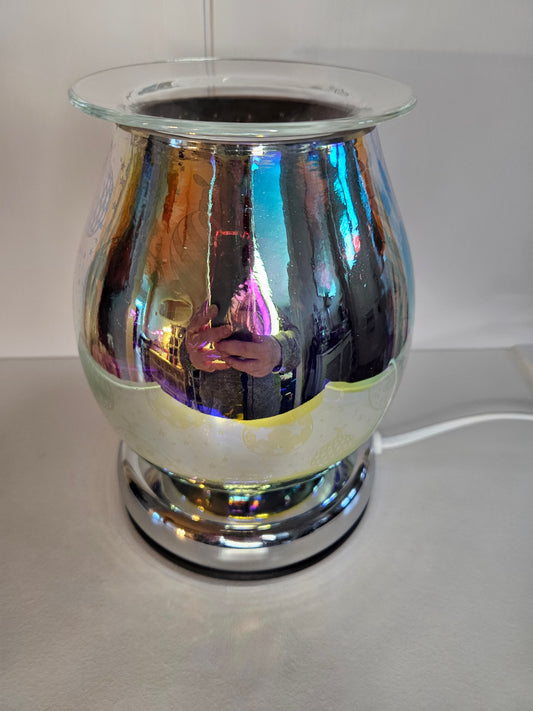 This wax or oil warmer has a silver tone when unlit