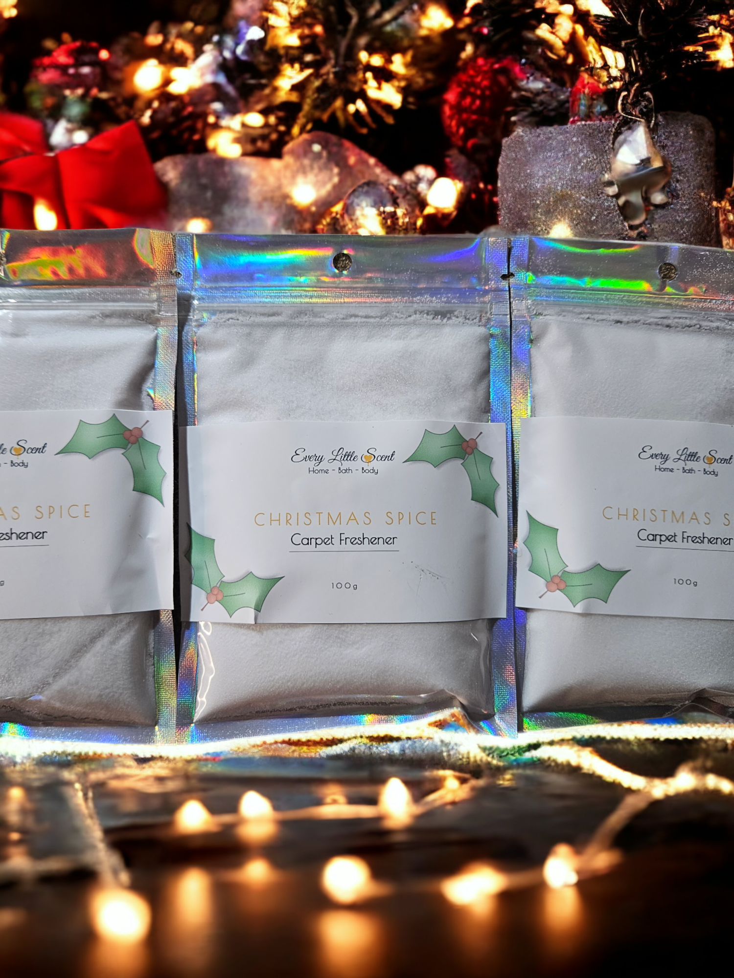 3 bags of white carpet freshener on a bed of colourful lights
