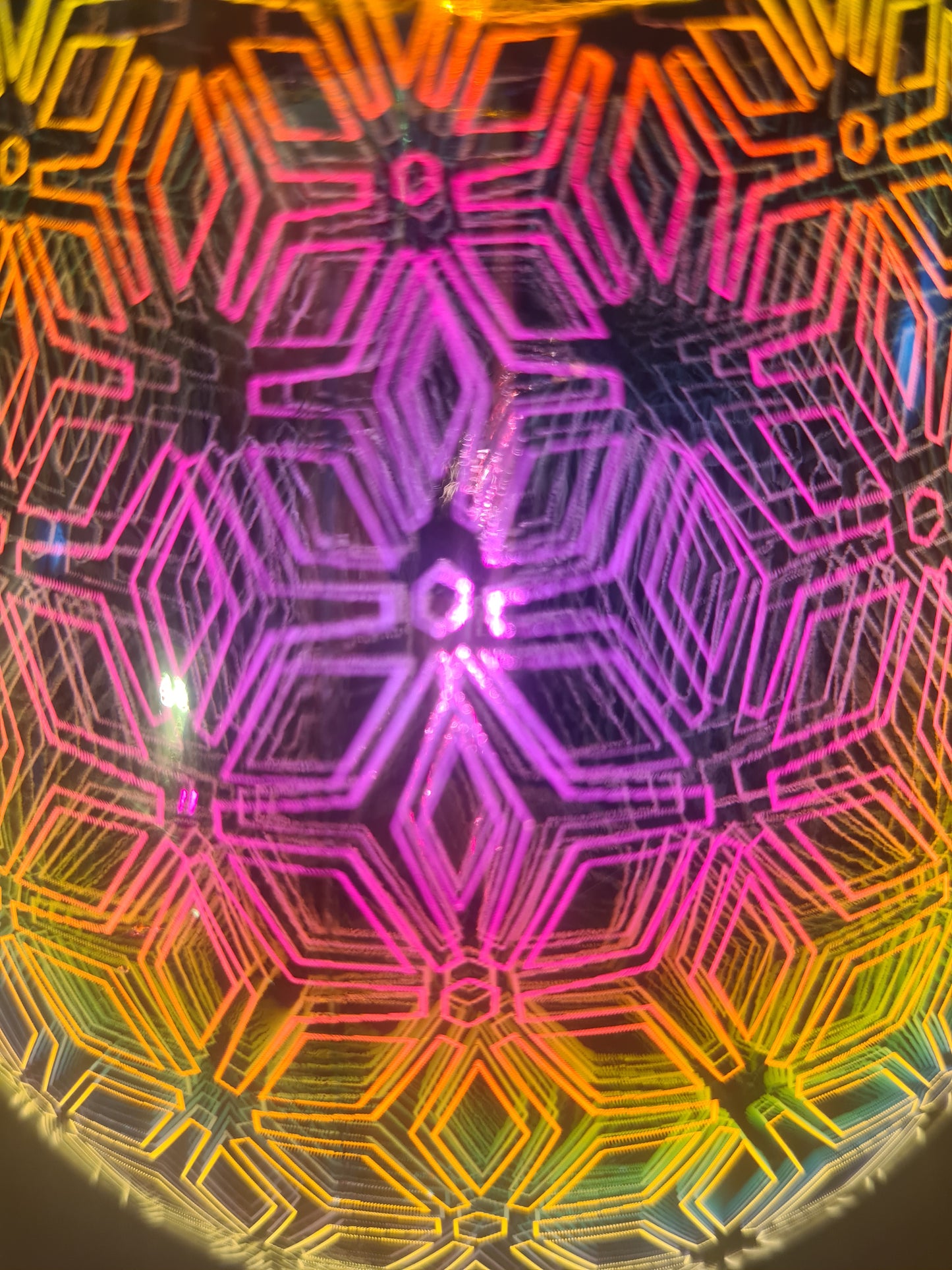 A close up of the geometric flower warmer showing the lit pattern in more detail 