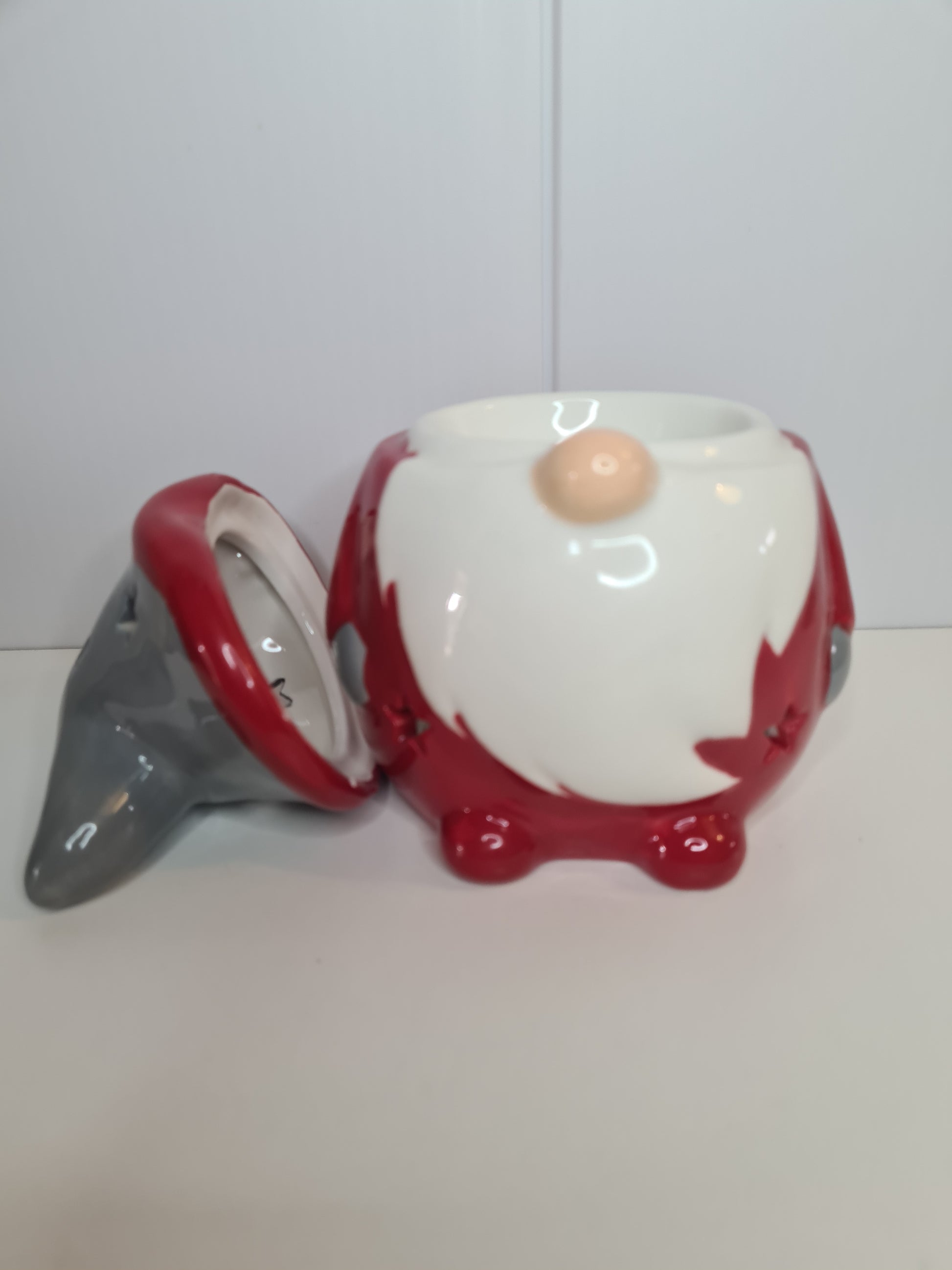 The gonk / gnome wax or oil burner with his hat removed showing where the wax or oil is placed