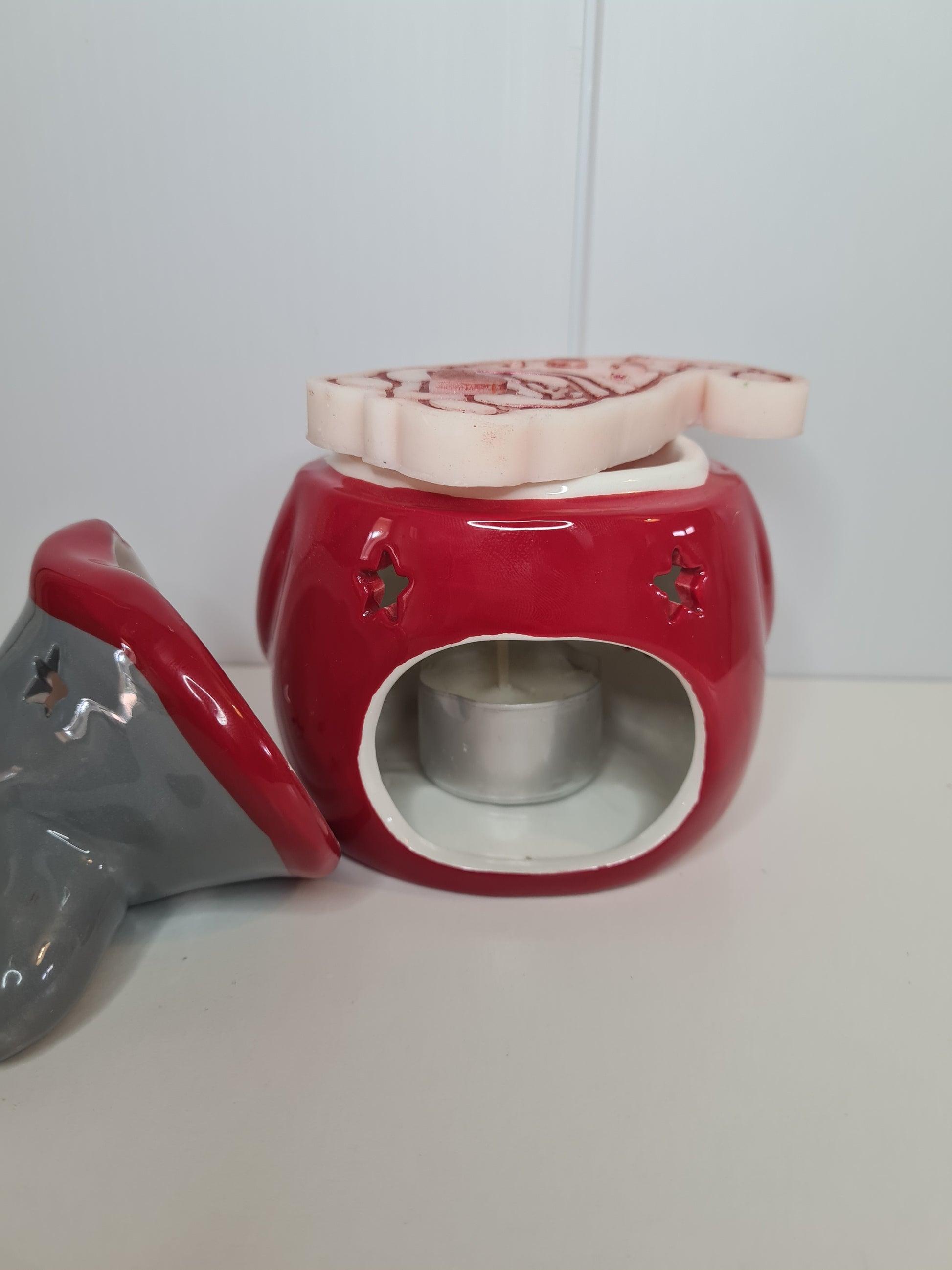 Showing the back of our gonk with a tea light inside and on the top is a gonk wax melt
