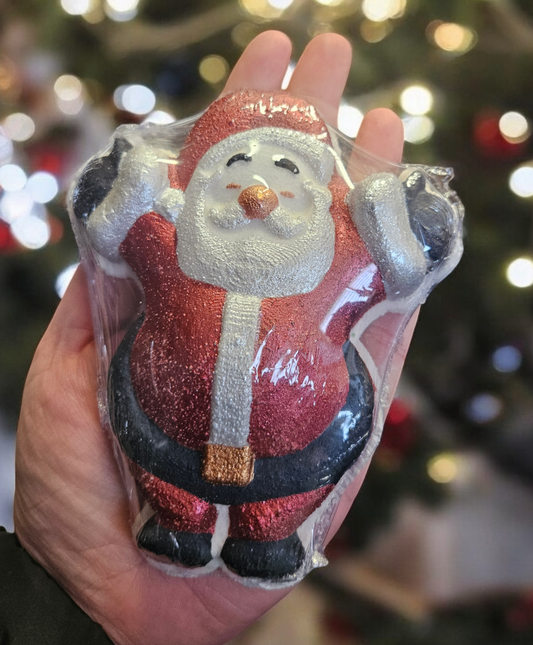 An adult hand sized santa bath bomb in the traditional colours of red, lack and white