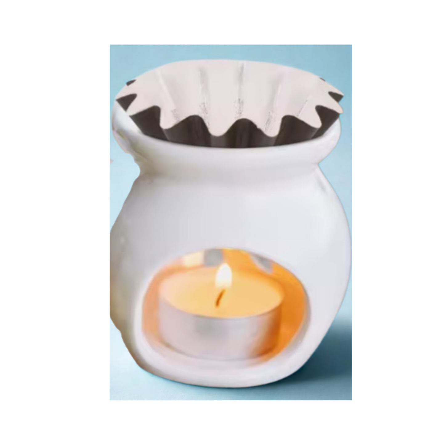 Wax warmer with a lit candle inside with a black wax melt liner on top