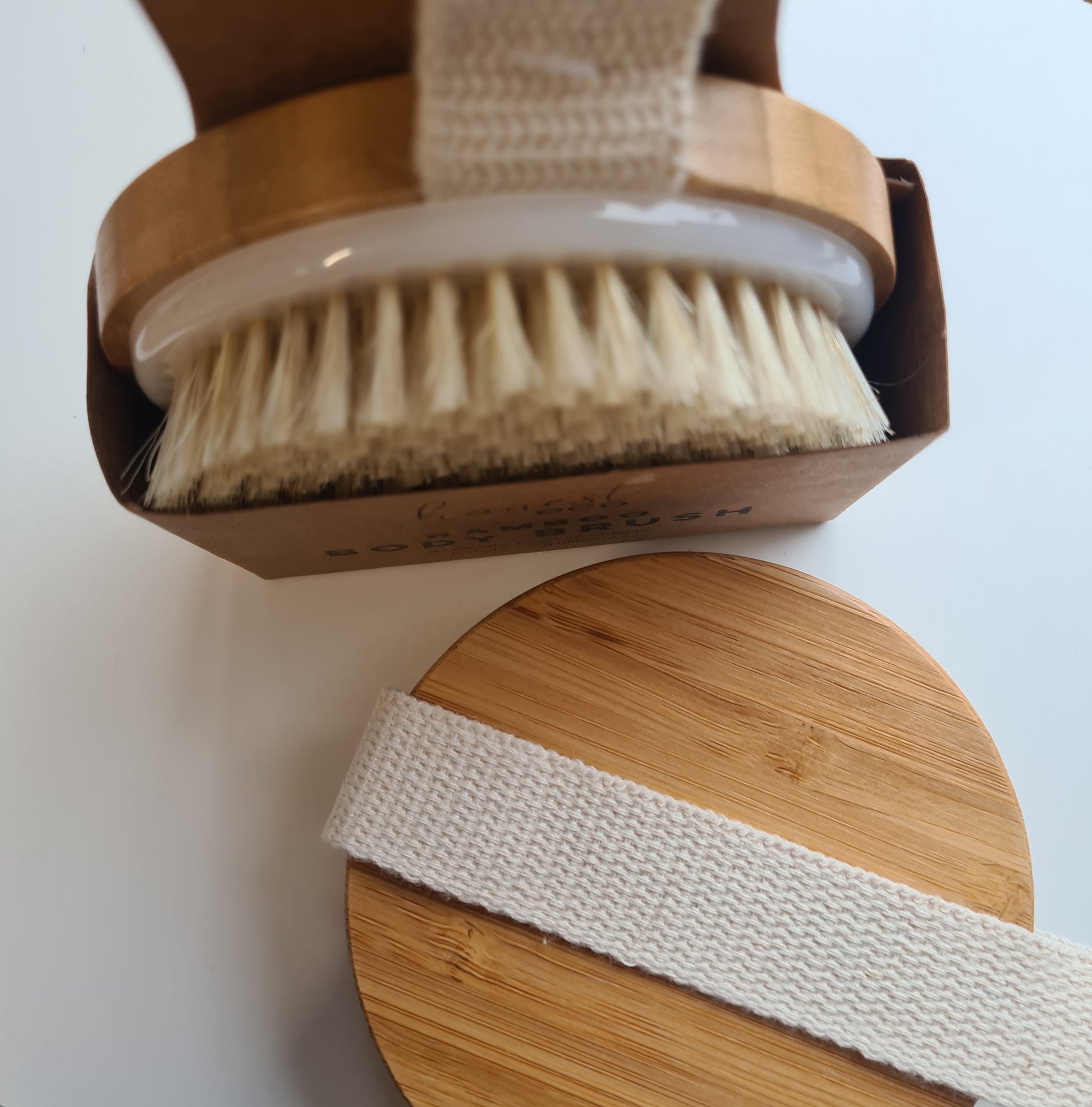Another view of our bamboo body brush showing both the top view and the bamboo top with strap