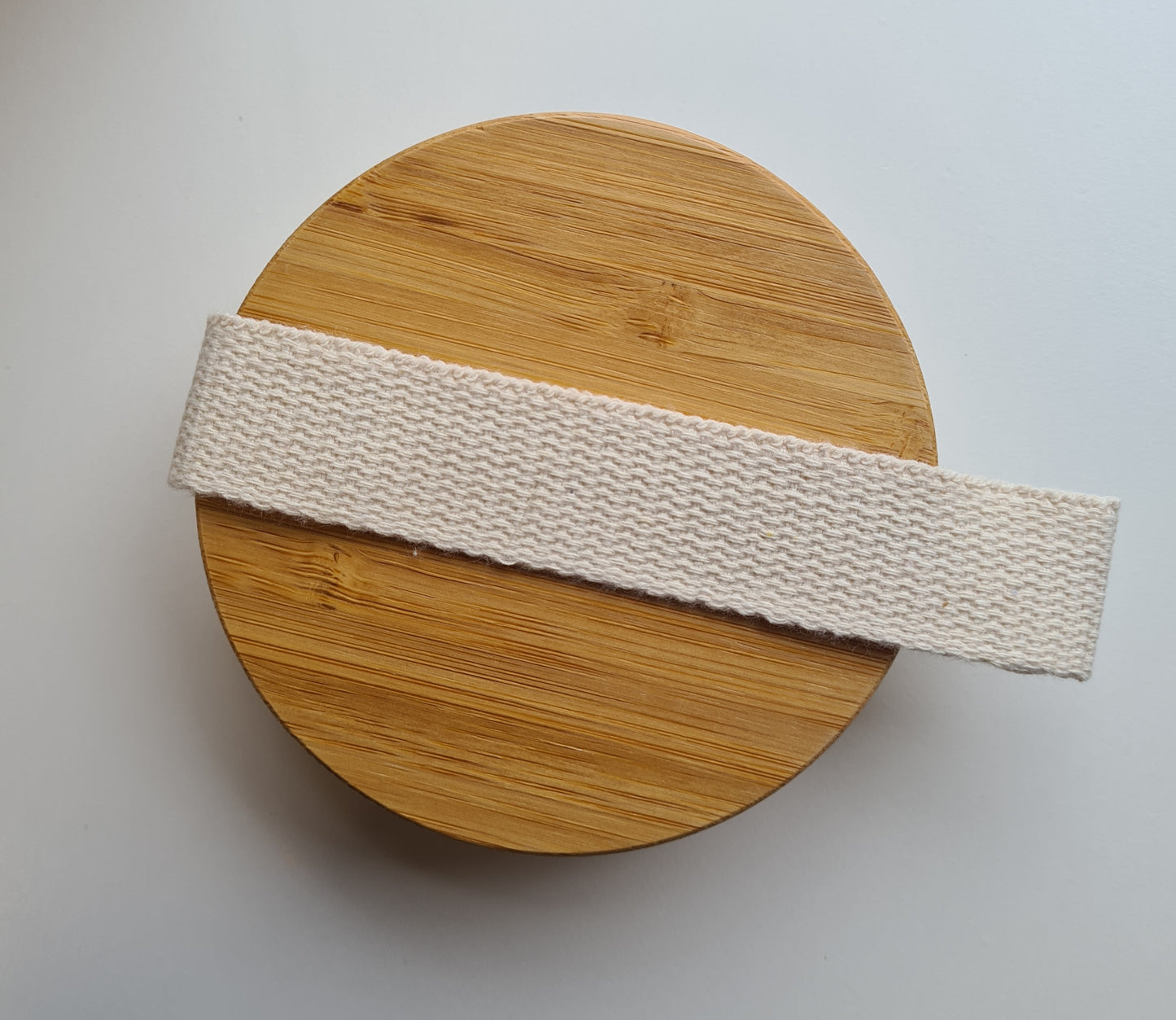 A view of the bamboo side of the body brush showing the cloth strap handle
