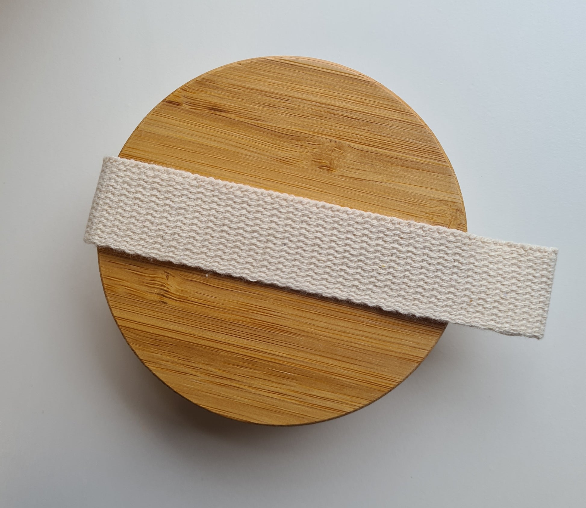 A view of the bamboo side of the body brush showing the cloth strap handle